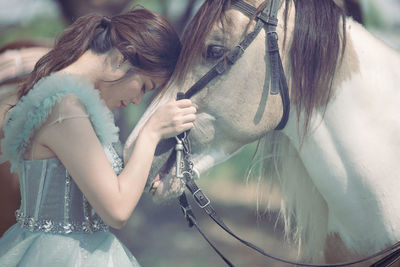 At sunset, a beautiful sensual girl and her horse go through the woods. horses are adored by girls.