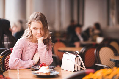 Teenager girl sitting at restaurant