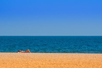 Scenic view of sea against clear blue sky