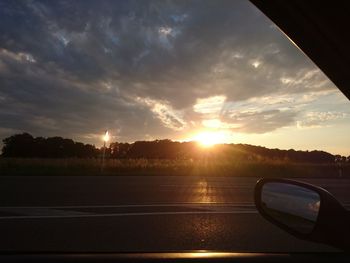 Cars on road at sunset