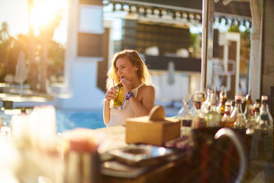 Young woman drinking cocktail