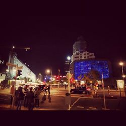 Illuminated city street at night