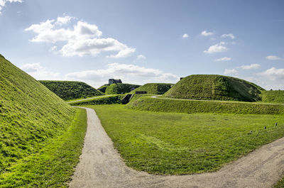 Path on the green ramparts under a blue sky