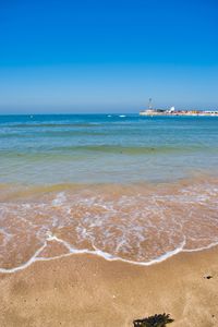 Scenic view of sea against blue sky