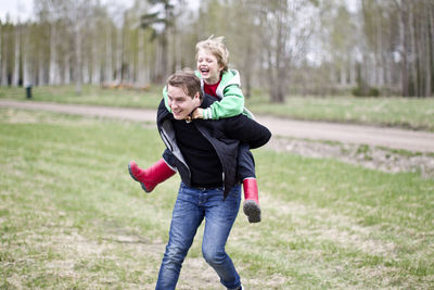 Man carrying son on shoulders, uppsala, sweden