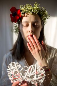 Portrait of young woman holding christmas tree