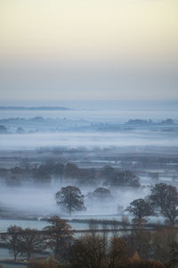 Scenic view of landscape against sky during winter