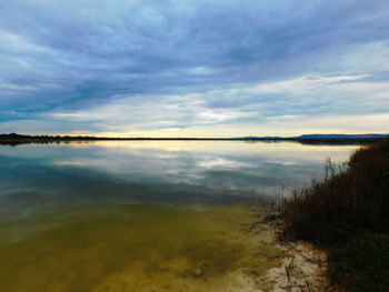 Scenic view of calm lake against sky