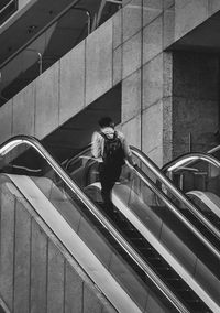 Low angle view of people walking on escalator