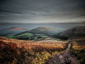 Scenic view of landscape against dramatic sky