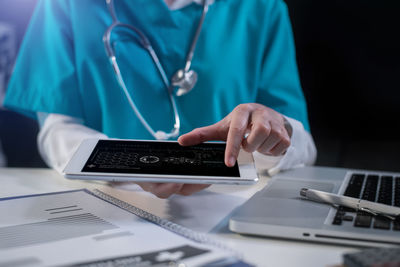 Midsection of man using mobile phone