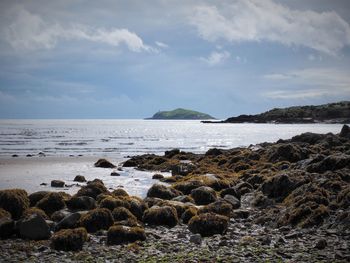Scenic view of sea against cloudy sky