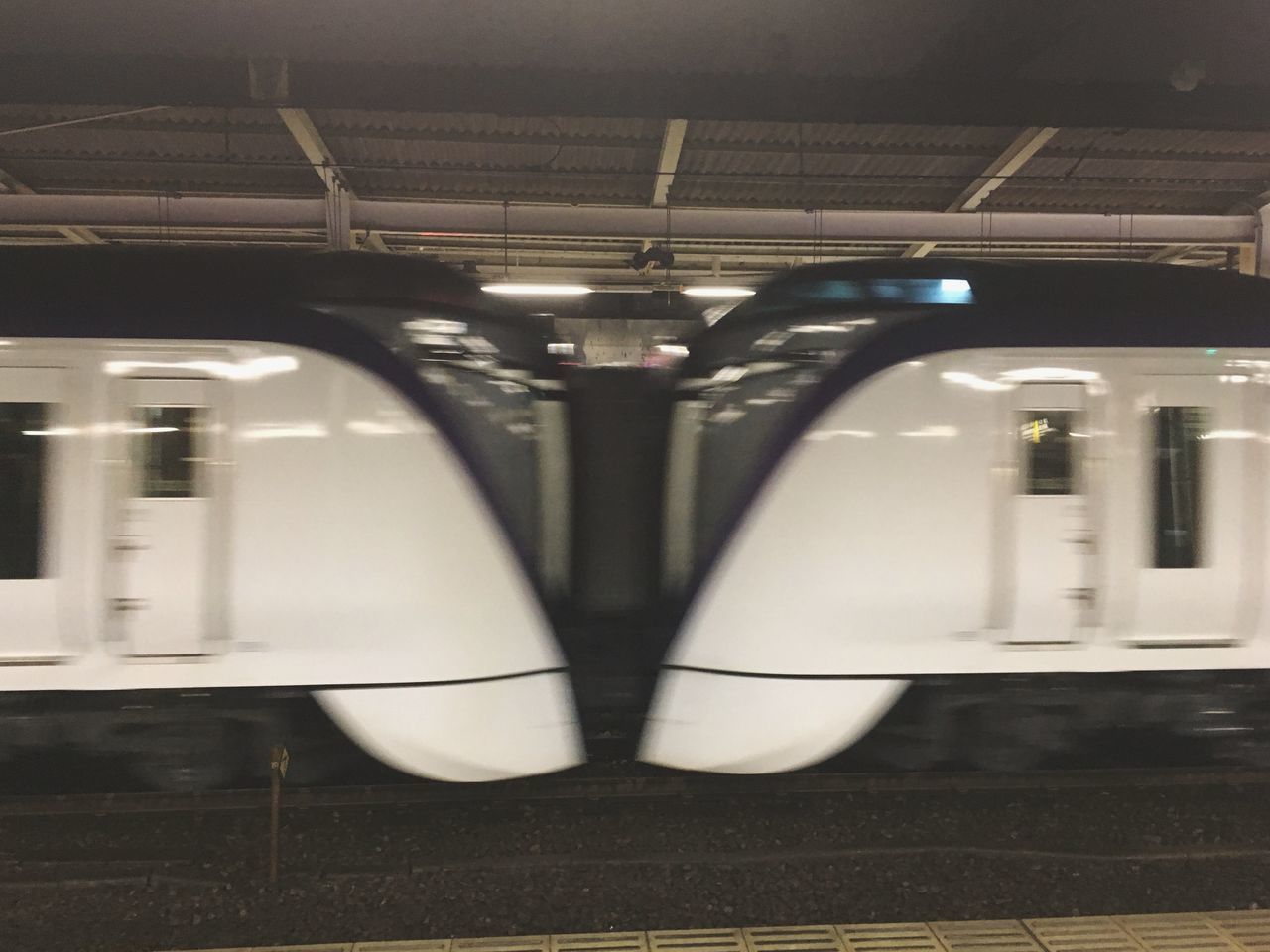 TRAIN AT ILLUMINATED UNDERGROUND STATION