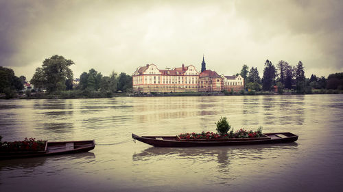 Boats in river against sky