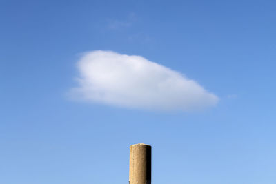 View of a cloud on the telegraph pole against the clear sky