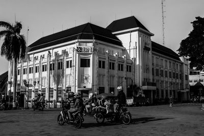 Bicycles on street against buildings in city