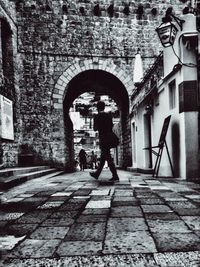 Low angle view of woman standing in front of building