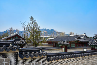 Traditional houses against mountain range