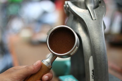 Close-up of hand holding coffee cup