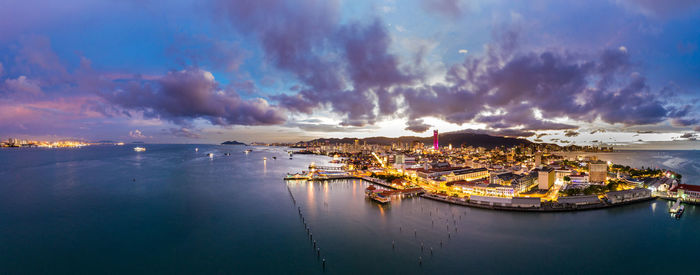 Panoramic view of sea and cityscape against sky