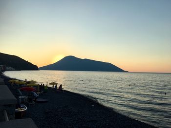 Scenic view of sea against clear sky at sunset