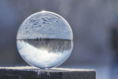 Close-up of crystal ball against blurred water