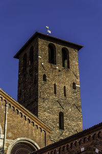 Low angle view of historic building against clear blue sky