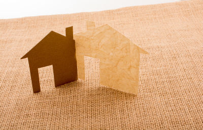 Close-up of paper and cardboard model homes at table