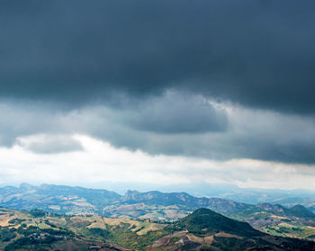 Scenic view of mountains against cloudy sky