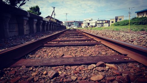 Railroad tracks amidst trees against sky