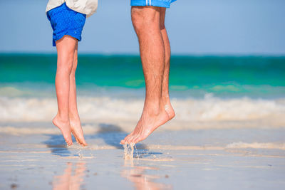 Low section of person standing on beach