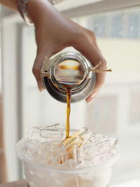 Close-up of hand holding glass jar
