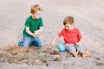 Boys playing with sand at playground