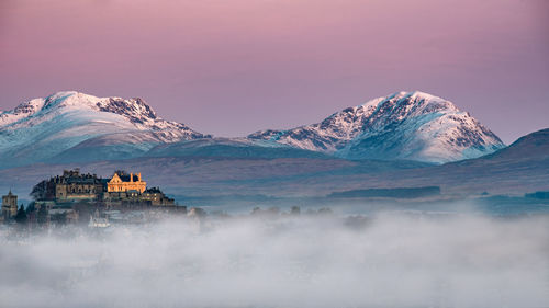 Scenic view of snowcapped mountains against sky during winter