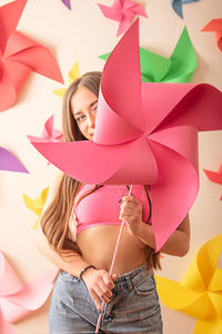 Low section of woman holding colorful balloons