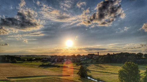 Scenic view of field against sky during sunset