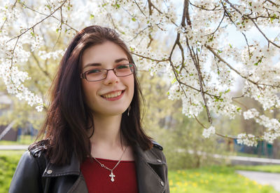 Portrait of a smiling young woman against blue sky