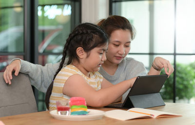 Smiling woman using laptop at table