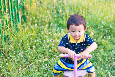 Cute girl sitting on field