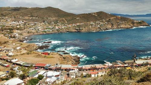 High angle view of sea by mountain