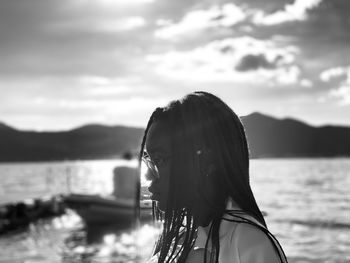 Portrait of woman against sea against sky