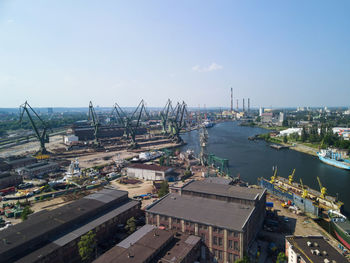 High angle view of buildings by sea against sky