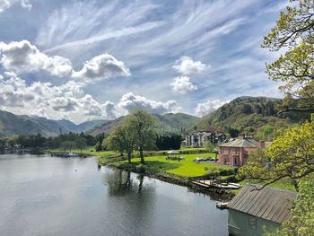 Scenic view of lake and buildings against sky