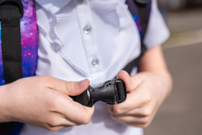 Back to school. girl in uniform with parent go to school with backpack behind their backs. beginning 