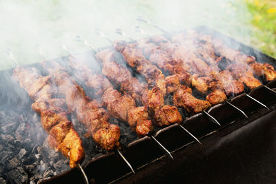 High angle view of meat on barbecue grill