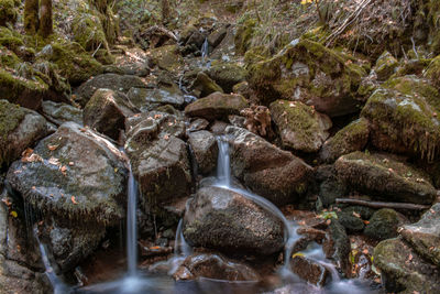 View of waterfall with rocks in foreground