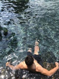 High angle view of woman swimming in sea