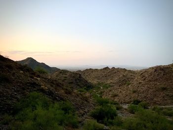 Scenic view of mountains against clear sky during sunset