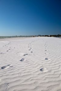 Scenic view of beach against clear sky