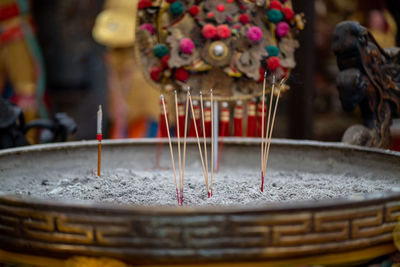 Close-up of lit candles in temple